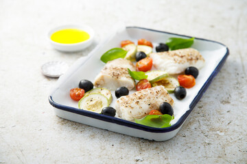 Roasted cod with olives, tomato and zucchini