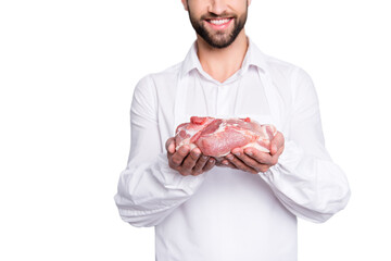 Close up cropped portrait of cheerful half face butcher demonstrate fresh meat in his arms, ...