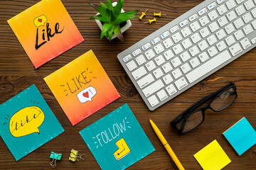 Social media icons on the table with keyboards and stationery