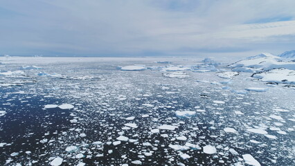 Climate Change: Melting Ice. Aerial Flight Over Antarctica Ice Frozen Ocean Water. Drone Overview Of Polar Ocean. Pieces Of Ice, Snow Floating In Cold Water. Wild Untouched Environment. Permafrost.