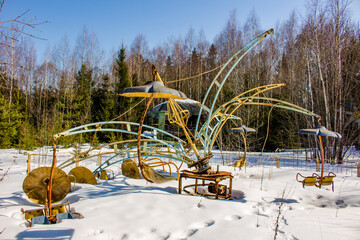 Broken construction of a children's carousel on the territory of an abandoned children's camp