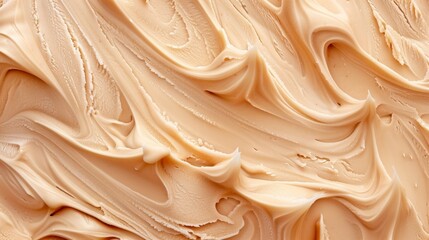 Close-up view of smooth and creamy beige foundation texture with swirls.