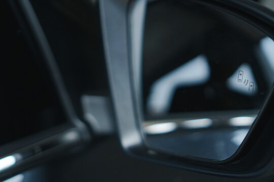 Blind Spot Monitoring system warning light/icon in side view mirror of new car