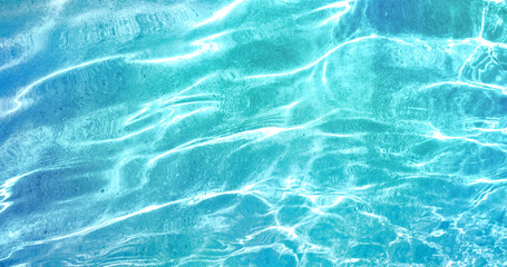 Beautiful turquoise blue ocean water surface with light reflections and highlights. Texture of...