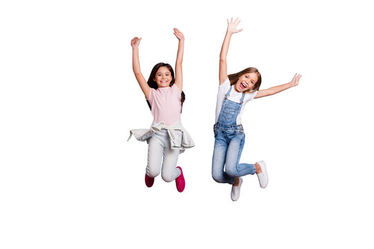 Full length body size view of two people attractive charming cheerful careless carefree straight-haired pre-teen girls having fun party overjoy great weekend day isolated on blue pastel background