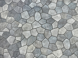 Seamless flagstone outdoor paving textures, or cobblestone cut flat in random pieces, grey, light grey, charcoal color. Monochrome stone slabs. Pavement and landscape paving stone background