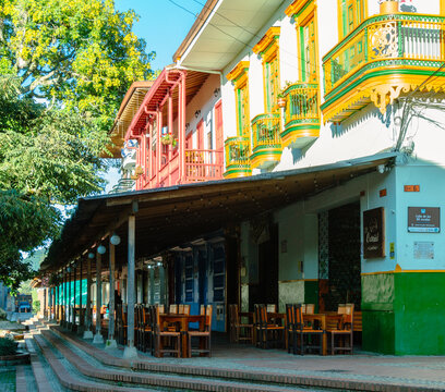 Jerico, Antioquia, Colombia, 08 08 2023 : Beautiful traditional facade of a restaurant on the main square of the historical village, pueblo, of Jerico, Jeric&oacute; . Colored wooden windows and balconies.