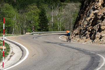 Man riding a bicycle on a mountain road