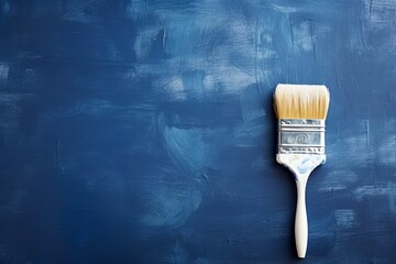 Paintbrush on an empty indigo background, with copy space for photo text or product, blank empty copyspace