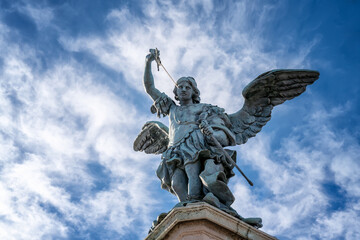 Fototapeta na wymiar Detailed close up view of Saint Michael archangel statue with wings and sword at top of Saint Angelo castle, Rome, Italy. .