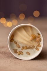 Craft natural ice cream in a paper bucket, the taste of pear with gorgonzola cheese