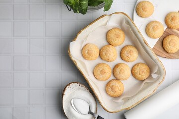 Tasty sweet sugar cookies in baking dish and mint on white tiled table, flat lay. Space for text