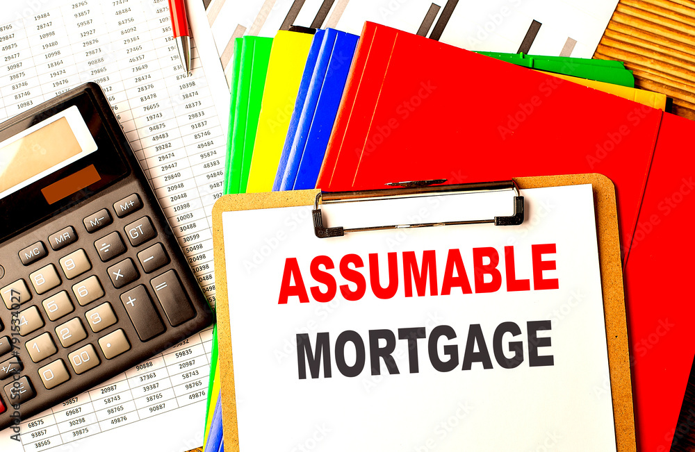 Aufkleber assumable mortgage text on clipboard with calculator and color folder