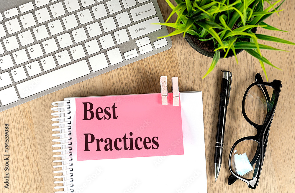 Poster best practices text pink sticky on notebook with keyboard, pen and glasses