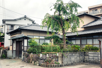 A small traditional Japanese house with a small courtyard and garden
