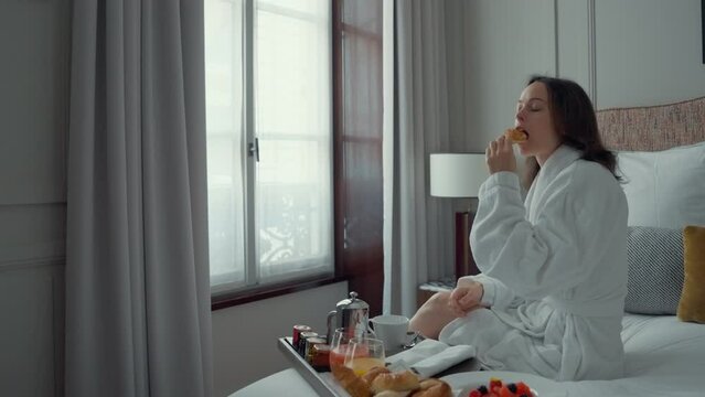 Woman Eating Breakfast in Hotel Room