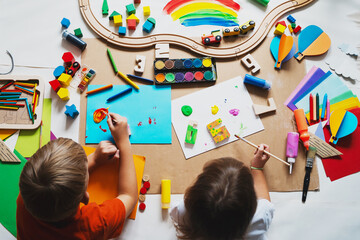 Children drawing and making crafts in kindergarten or daycare. - 791549049