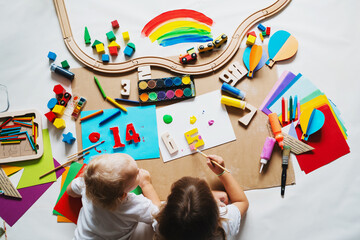 Children drawing and making crafts in kindergarten or daycare.
