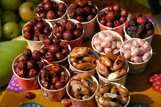 Local people selling ranmeva at the Mahabaleshwar Forest food the real taste of nature, blueberry, Red strawberries, berries, beetroots, indian gooseberry, tamarind.