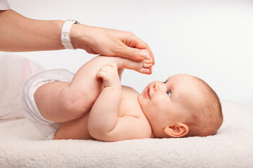 Physiotherapist performing infant development exercise