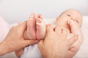 Physiotherapist performing development exercise with infant