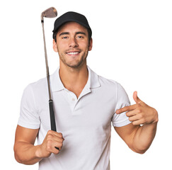 Young Hispanic man with golf club person pointing by hand to a shirt copy space, proud and confident