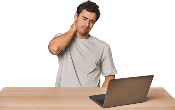 Hispanic young man working on laptop having a neck pain due to stress, massaging and touching it with hand.