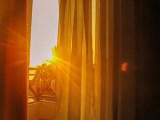 The sun at dawn shines through the window in the hotel	
