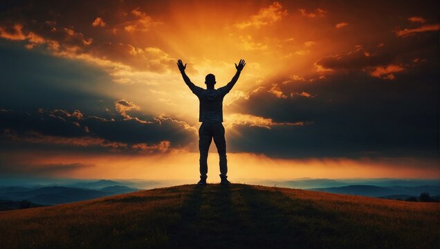 Man celebrating success on hilltop at sunset