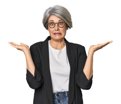 Caucasian mid-age female in business suit confused and doubtful shrugging shoulders to hold a copy space.