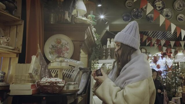 girl sniffs a candle in a souvenir shop