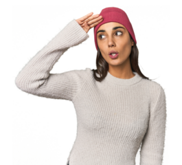 Hispanic young woman looking far away keeping hand on forehead.