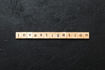 investigation word written on wood block. investigation text on table, concept