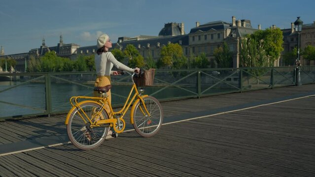Woman with Bicycle on Bridge