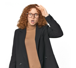 Young Caucasian redhead in business attire shouts loud, keeps eyes opened and hands tense.