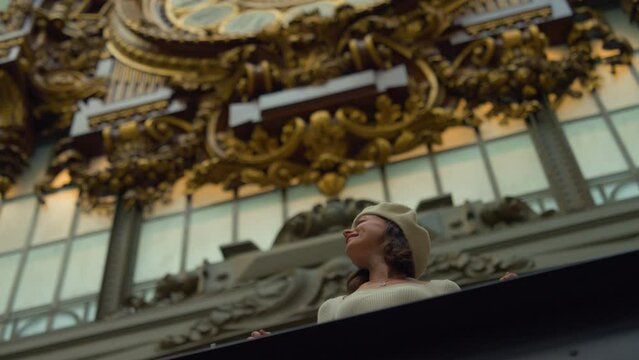 Woman Admiring Ornate Gilded Architecture