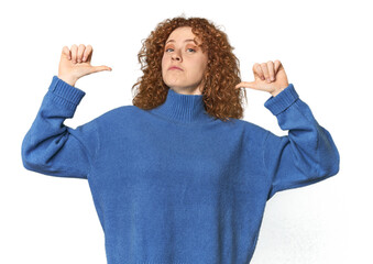 Young Caucasian redhead woman feels proud and self confident, example to follow.