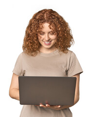 Young Caucasian redhead happy with laptop