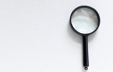 Black magnifier on a gray background.