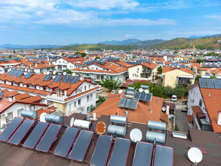 Close-up of photovoltaic solar panels from a drone on the roof of a country house. FETHIYE, Turkey. reducing the size of photovoltaic solar panels. Hot water boilers are heated by sunlight.
