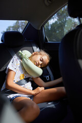 Young Girl Asleep in the Backseat of a Car on a Sunny Afternoon