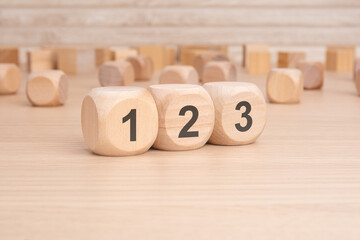 wooden cubes with number 123 on wooden background