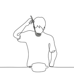 man tries soup from a ladle while standing over a saucepan - one line art vector. concept bachelor preparing homemade food