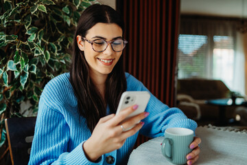 One young caucasian woman is using mobile phone to talk or send messages