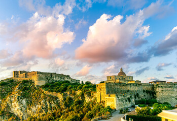 majestic evening landscape of beautiful old ancient castle on a mountain during beautiful sunset or...