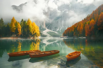 Poster Magical autumn landscape with boats on the lake in natural park in the Dolomites. © Hunman