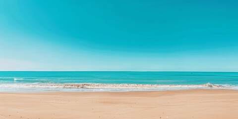 Panoramic view of the pristine beach with cliffs, clear blue sky and gentle waves on a sunny day