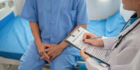 A female doctor is examining the body and taking notes on a sick person in a hospital examination...