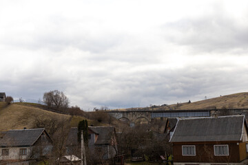 sky with white clouds over the house in the mountains