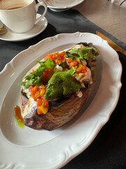 A plate of food with a green leafy vegetable on top